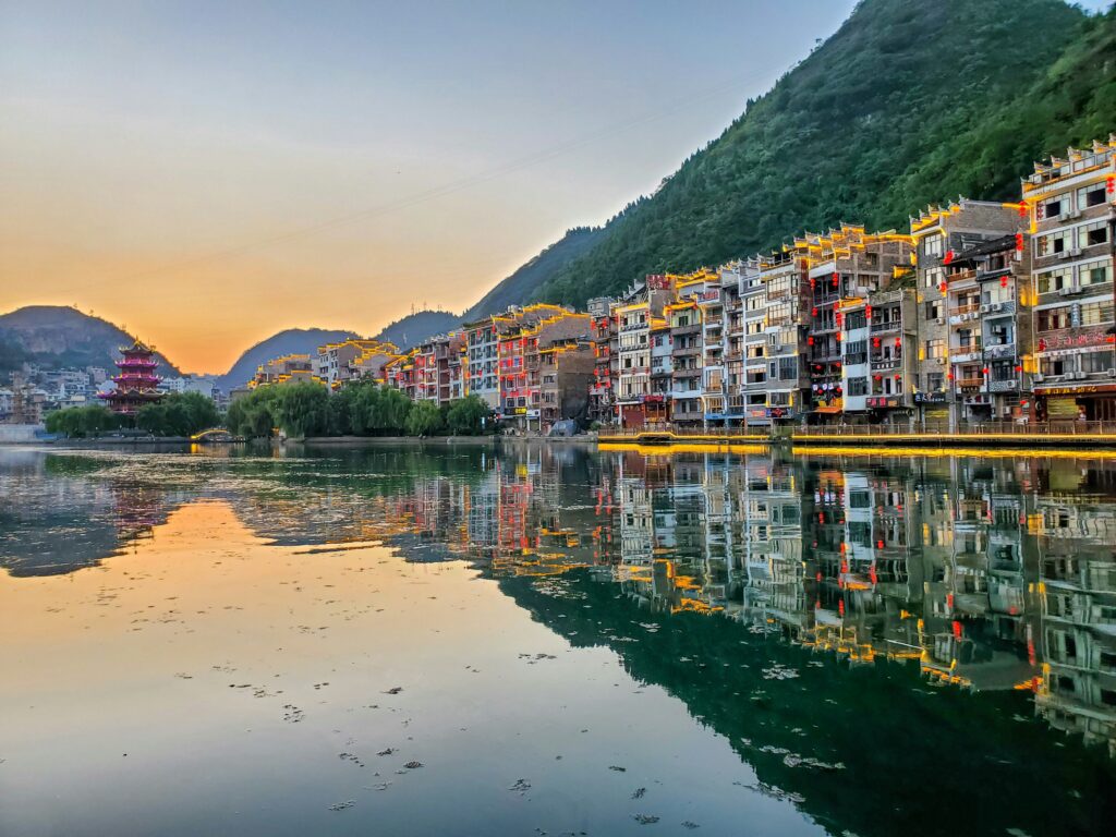 River with many colored houses 
on the banks by sunset