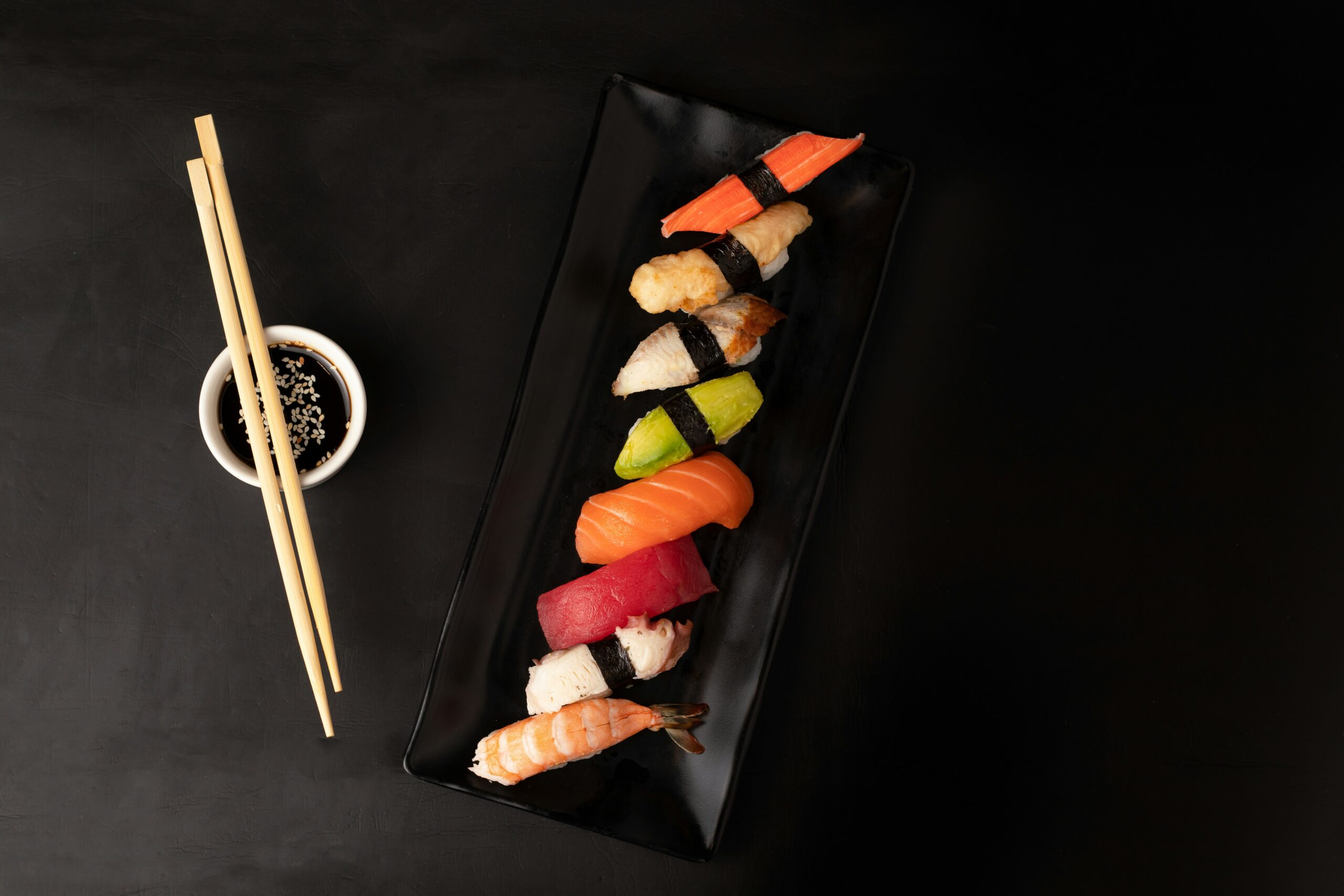 Sushis on a plate with black background