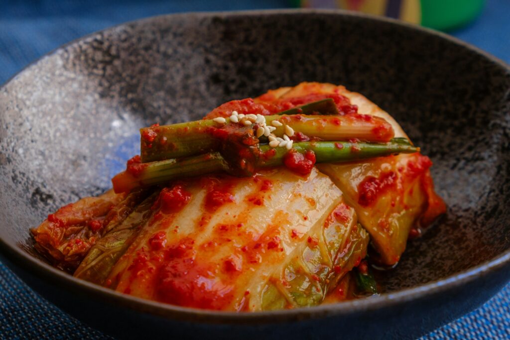 Kimchi served on a black plate