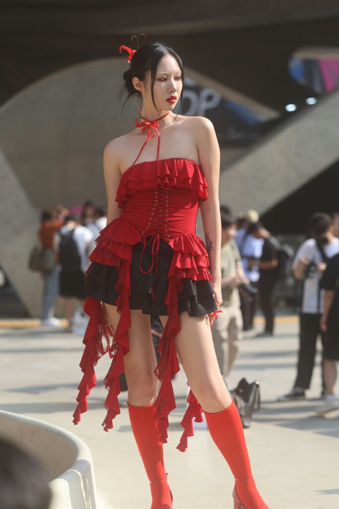 A tall, slim woman in a striking outfit on the street